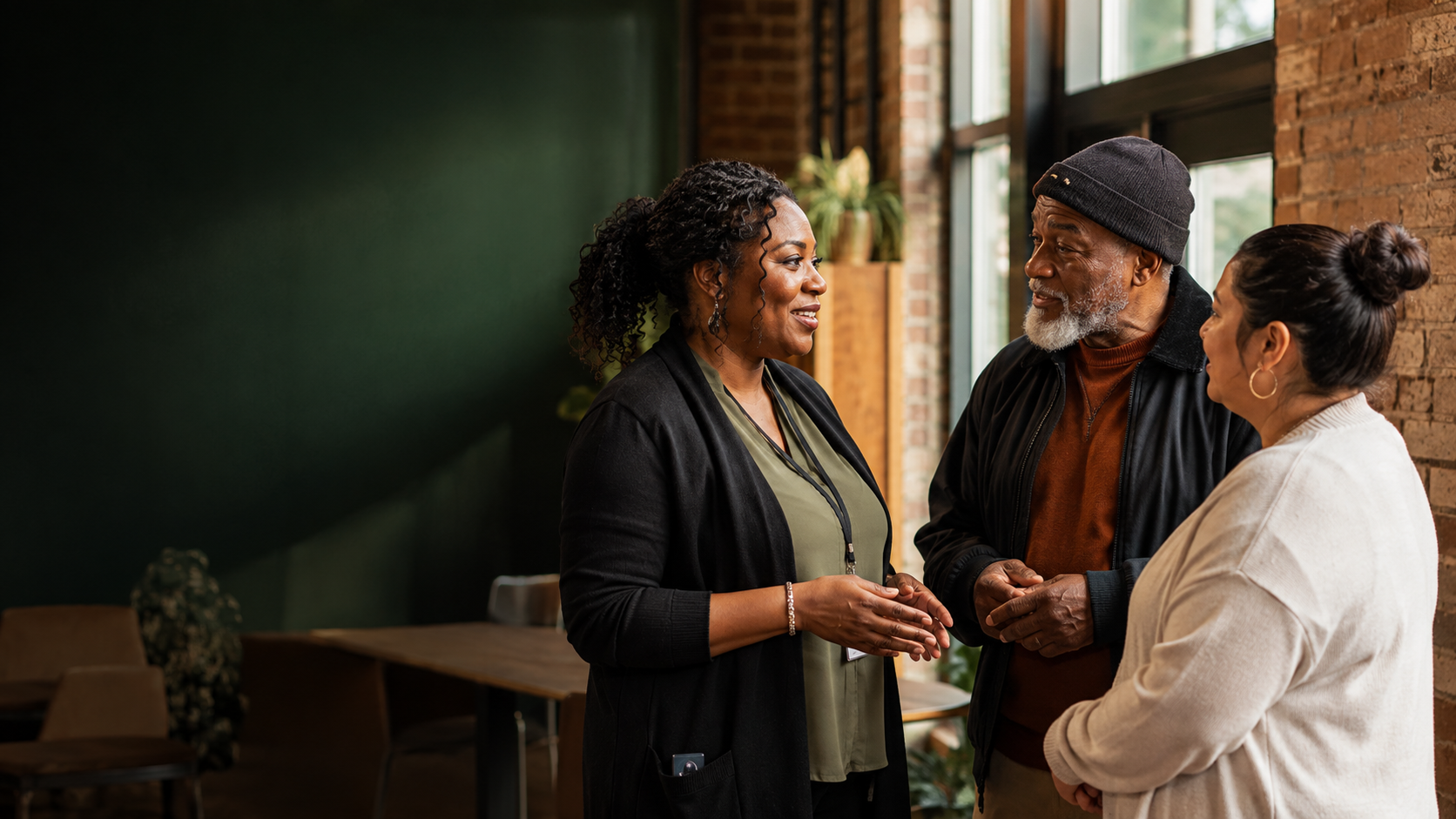 A community health worker in conversation with two Metro Detroit residents